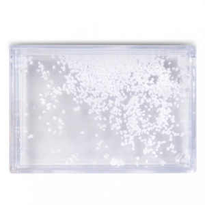 Photo frame with snow or sand and seashells or red hearts inside
